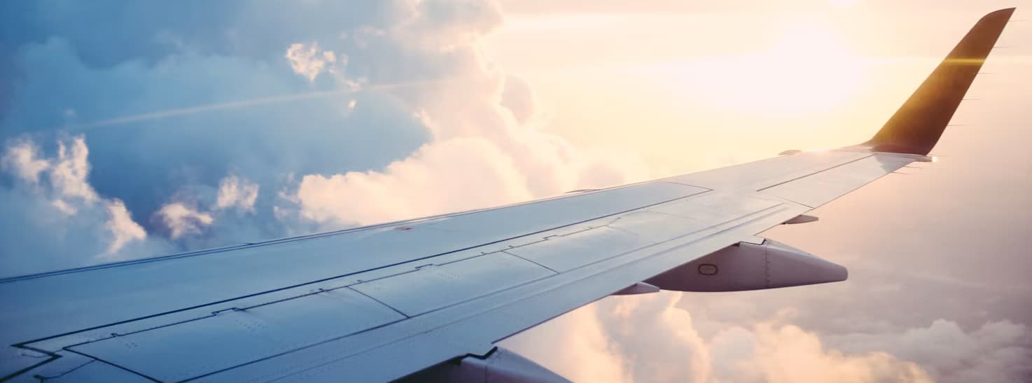 Airplane approaching a runway at sunset